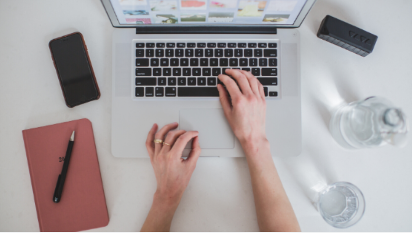 Homem sorrindo criando um curso online em um notebook moderno, com ícones de aprendizado digital flutuando.